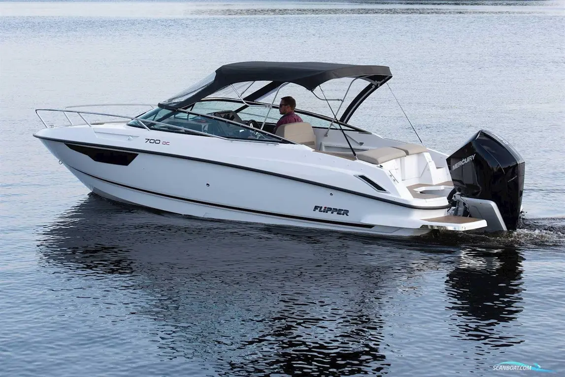 A white Flipper 700 DC boat with a driver on board, moving across calm water with a Mercury outboard motor visible.